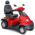 A bright red, four-wheeled mobility scooter with a comfortable black seat, armrests, and backrest. The scooter has rearview mirrors, a headlight, and a sturdy build suitable for outdoor use. It features large, rugged tires for stability on various terrains.