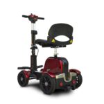 A compact, red-and-black mobility scooter with a cushioned seat, armrests, and four sturdy wheels. The scooter features a handlebar with control panel and is designed for easy maneuverability and comfortable travel for individuals with mobility challenges.