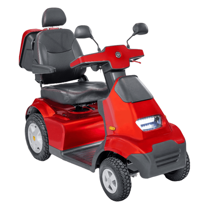 A bright red mobility scooter with a padded seat, backrest, and headrest. The scooter has handlebars for steering, a small front headlight, and four sturdy wheels designed for stability. The seat appears adjustable and includes armrests for added comfort.