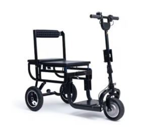 The image depicts the eFOLDi Lite Mobility Scooter. It is a compact, black-colored scooter with a large, cushioned seat and a backrest. The scooter has three wheels: two larger ones at the back and a smaller one in the front. The front of the scooter features a long, adjustable handlebar column with grips, and there appears to be a control mechanism on the handlebars. The design is sleek and modern, emphasizing portability and convenience, likely designed to be lightweight and easily foldable for storage and transport.
