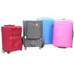 The eFOLDi Explorer mobility scooter folded among traditional luggage, illustrating its compact size comparable to carry-on suitcases.