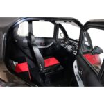 Interior view of Green Transporter Q Express showing the driver's seat with red and black upholstery, black dashboard, and side door open.