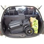 The eFOLDi Explorer neatly folded and stored in the trunk of a car among other items, showcasing its convenience for travel.