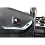 This image shows a close-up of a Green Transporter Q Express vehicle's interior door panel with electric window controls, featuring a chrome door handle and contrasting trim.