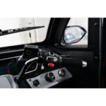 "Close-up of the control panel on the right side of a Green Transporter Q Express, featuring handlebar grip, ignition switch, and various buttons and dials.