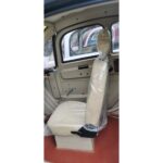 Interior side view of a GIO Golf mobility scooter, showing a wrapped driver's seat in beige.