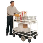 Mailroom worker using EK Tech Pony Express 1031-SM01 Motorized Mailroom Cart loaded with packages and envelopes on upper and lower shelves inside a warehouse or office mailroom.