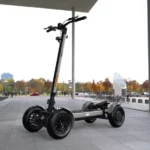 outdoor front angle view of MIA SPYQE 2x4 electric scooter in gray color on city pavement