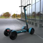 outdoor side view of MIA SPYQE 2x4 electric scooter in blue color parked on gray pavement