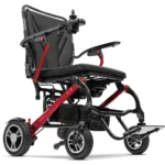 Forcemech Carbon F1 Lightweight Folding Power Wheelchair in red shown from a lower angle highlighting the frame wheels and footrest.